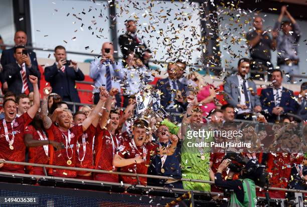Carlisle United players lift the League Two Play-Off trophy after their victory and promotion to League One during the Sky Bet League Two Play-Off...