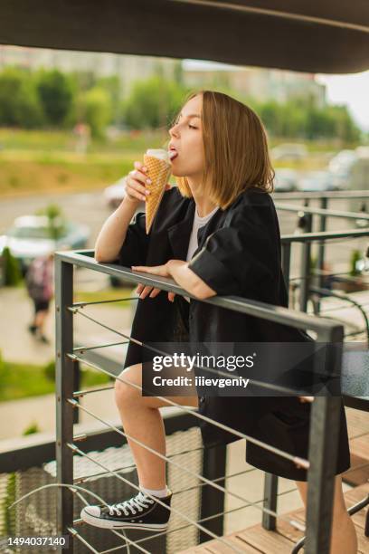 blonde woman eat ice cream in cone. summer heat - mint ice cream stock pictures, royalty-free photos & images