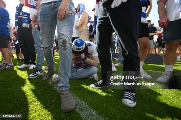 Fans of Hamburger SV look dejected after their team misses out on an automatic promotion to the Bundesliga after the team's victory in the Second...