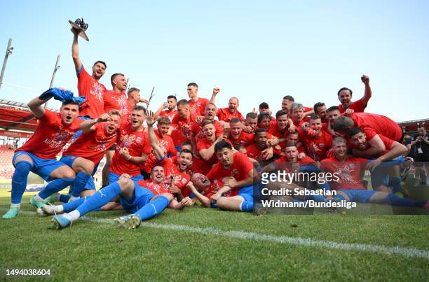 Heidenheim 1846 players celebrate after the team's victory and promotion as champions during the Second Bundesliga match between SSV Jahn Regensburg...