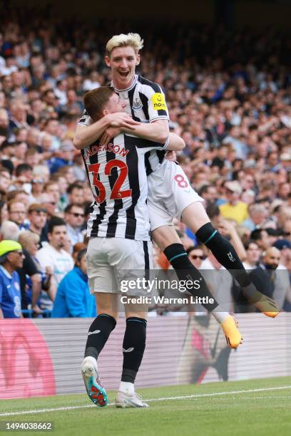 Anthony Gordon of Newcastle United celebrates with teammate Elliot Anderson after scoring the team's first goal during the Premier League match...