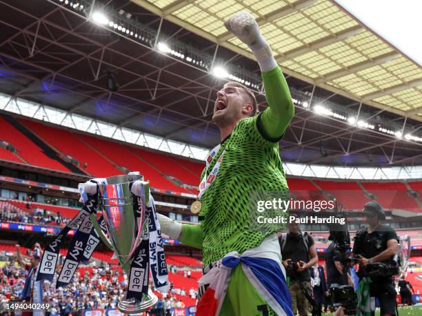 Tomas Holy of Carlisle United celebrates with the League Two Play-Off Trophy after the final whistle of the Sky Bet League Two Play-Off Final between...