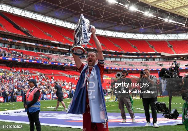 Paul Huntington of Carlisle United lifts the League Two Play-Off trophy after the final whistle of the Sky Bet League Two Play-Off Final between...