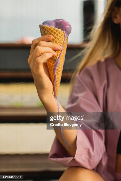 purple ice cream in cone. summer heat - human hand 3d stock pictures, royalty-free photos & images