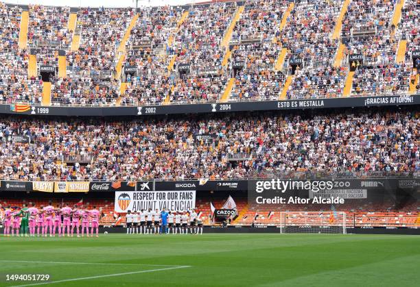 Empty seats are seen inside the stadium where a banner reads "Juntos Contra El Racismo Together against Racism" as both teams line up prior to the...