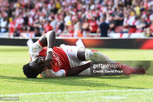 Bukayo Saka of Arsenal lays injured during the Premier League match between Arsenal FC and Wolverhampton Wanderers at Emirates Stadium on May 28,...