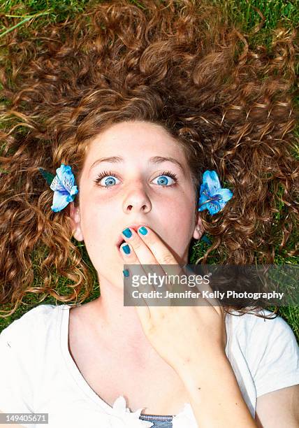 young blue eyed girl hands over mouth - jennifer kelly stock pictures, royalty-free photos & images