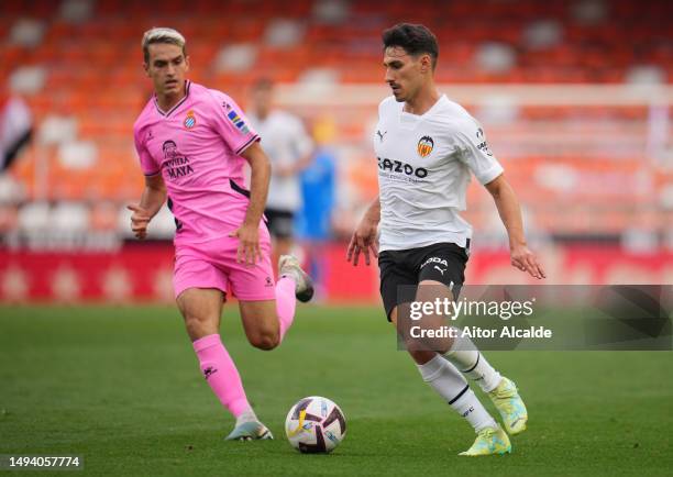 Denis Suarez of RCD Espanyol battles for possession with Andre Almeida of Valencia CF during the LaLiga Santander match between Valencia CF and RCD...