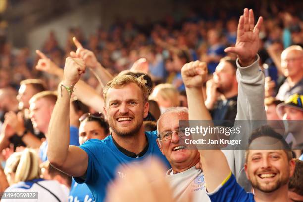 Fans of Everton celebrate after their sides victory, which secures their position in the Premier League next season, in the Premier League match...