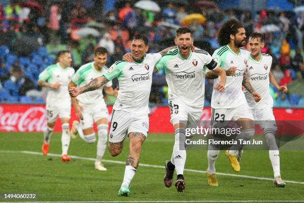 Chimy Avila of Osasuna celebrates with David Garcia after scores the first goal of his team during the LaLiga Santander match between Getafe CF and...