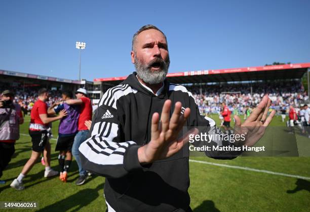 Tim Walter, Head Coach of Hamburger SV stops fans from running on the pitch and celebrating after the final whistle of the Second Bundesliga match...