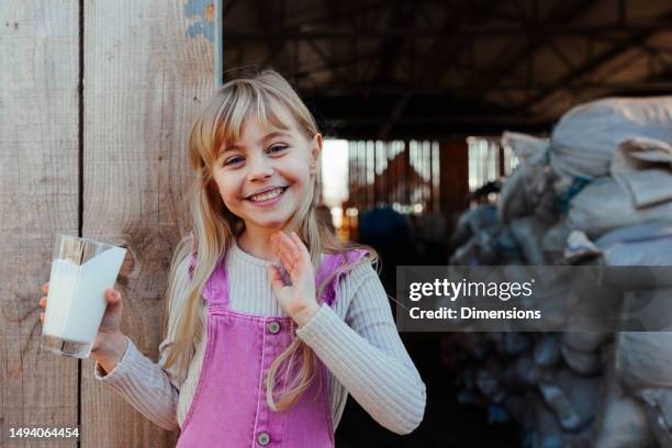 joyful girl with glass of milk at farm. - farm corral stock pictures, royalty-free photos & images