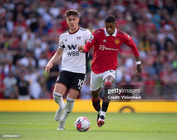 Marcus Rashford of Manchester United and Tom Cairney of Fulham in action during the Premier League match between Manchester United and Fulham FC at...