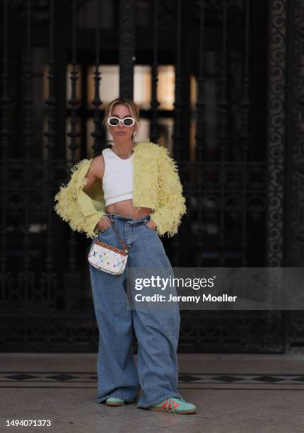 Karin Teigl wearing Louis Vuitton vintage white colorful monogram bag, Adidas Gazelle orange and blue sneaker, CYK white bra top, The Frankie Shop...