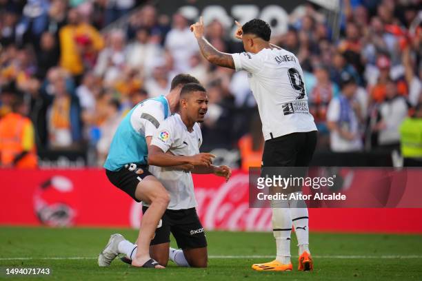 Lino of Valencia CF celebrates with teammates Toni Lato and Justin Kluivert after scoring the team's second goal during the LaLiga Santander match...