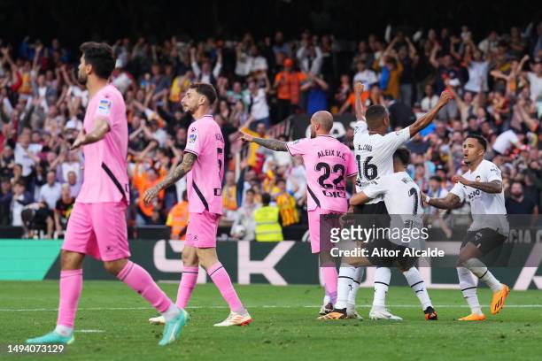 Lino of Valencia CF celebrates with teammates Hugo Duro and Justin Kluivert after scoring the team's second goal during the LaLiga Santander match...