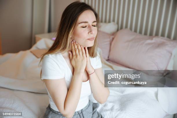 i'll have to get something for this cough - caucasian woman sick in bed coughing stock pictures, royalty-free photos & images