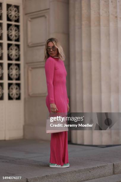 Karin Teigl wearing Adidas Gazelle mint green and white sneaker, Jacquemus pink long cotton dress, Louis Vuitton Capucines rose leather bag, Julia...