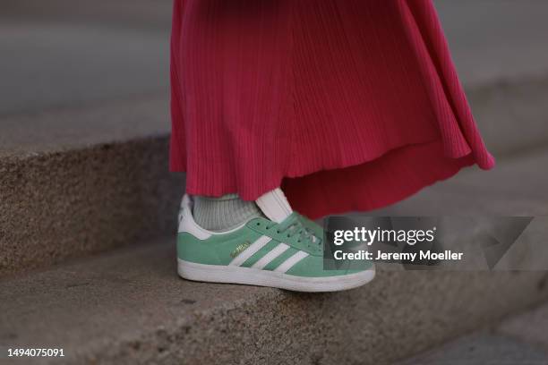 Karin Teigl wearing Adidas Gazelle mint green and white sneaker, Jacquemus pink long cotton dress, Louis Vuitton Capucines rose leather bag, Julia...