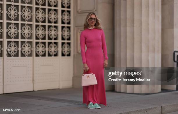 Karin Teigl wearing Adidas Gazelle mint green and white sneaker, Jacquemus pink long cotton dress, Louis Vuitton Capucines rose leather bag, Julia...