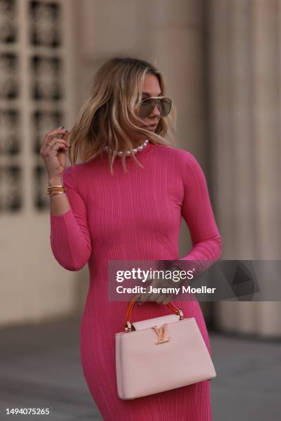 Karin Teigl wearing Adidas Gazelle mint green and white sneaker, Jacquemus pink long cotton dress, Louis Vuitton Capucines rose leather bag, Julia...