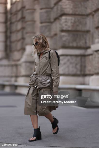 Karin Teigl wearing Miu Miu earth tones logo flannel, Miu Miu matching midi skirt, Miu Miu Pocket belt, Miu Miu Pocket black leather bag, Miu Miu...