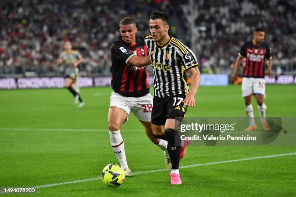 Malick Thiaw of AC Milan battles for possession with Filip Kostic of Juventus during the Serie A match between Juventus and AC MIlan at Allianz...