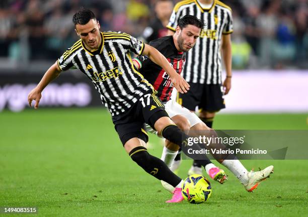 Filip Kostic of Juventus battles for possession with Davide Calabria of AC Milan during the Serie A match between Juventus and AC MIlan at Allianz...