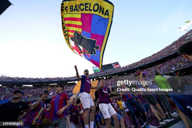 Supporters of FC Barcelona waves their flags during the LaLiga Santander match between FC Barcelona and RCD Mallorca at Camp Nou on May 28, 2023 in...