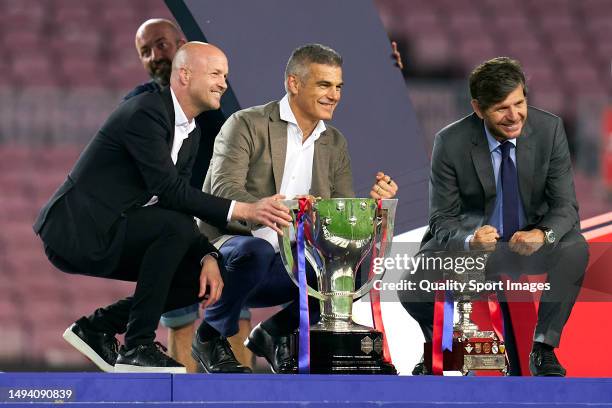 Jordi Cruyff, Enric Masip and Mateu Alemany pose with the trophies after the last match at the stadium ahead of the remodelling works at the end of...