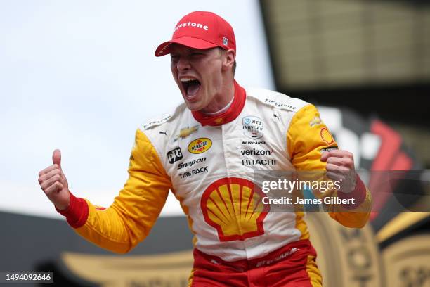 Josef Newgarden, driver of the PPG Team Penske Chevrolet, celebrates by pouring milk on his head after winning the 107th Running of Indianapolis 500...