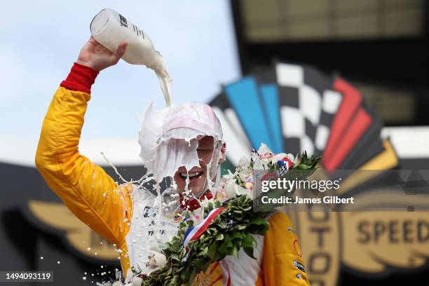 Josef Newgarden, driver of the PPG Team Penske Chevrolet, celebrates by pouring milk on his head after winning the 107th Running of Indianapolis 500...