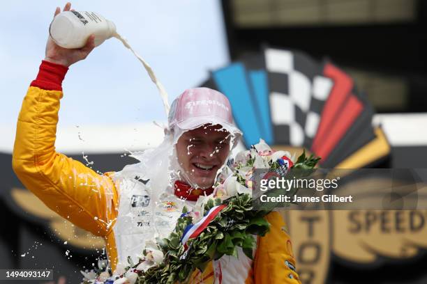 Josef Newgarden, driver of the PPG Team Penske Chevrolet, celebrates by pouring milk on his head after winning the 107th Running of Indianapolis 500...