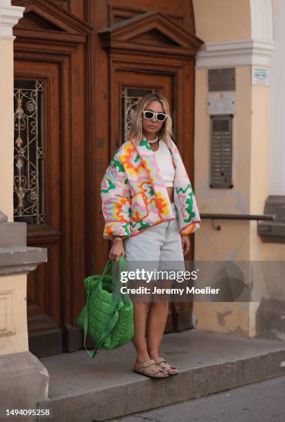 Karin Teigl wearing VeeCollective green big puffer bag, Dior white shades, Zara jeans shorts, Hermes Chypre beige velvet leather sandals, CYK white...