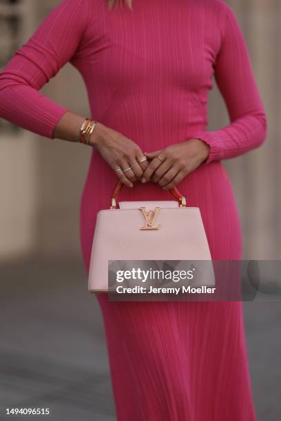 Karin Teigl wearing Adidas Gazelle mint green and white sneaker, Jacquemus pink long cotton dress, Louis Vuitton Capucines rose leather bag, Julia...