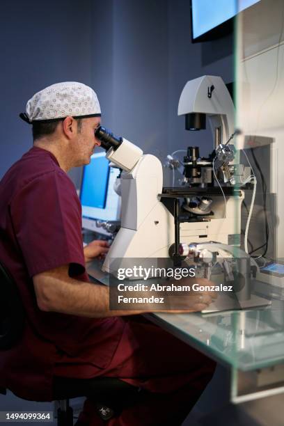 Doctor Using A Microscope 55 Microbiological Research Establishment Stock Photos, High-Res ...