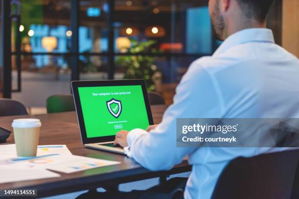 businessman looking at a antivirus security log in screen on a computer - security screen icons stock pictures, royalty-free photos & images