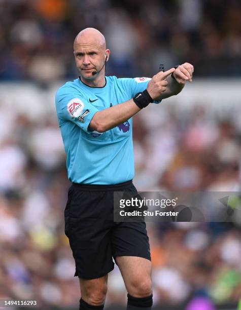 Referee Anthony Taylor points at his watch during the Premier League match between Leeds United and Tottenham Hotspur at Elland Road on May 28, 2023...
