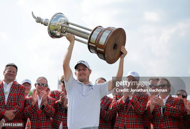 Emiliano Grillo of Argentina hoists the trophy after winning the Charles Schwab Challenge in a playoff at Colonial Country Club on May 28, 2023 in...