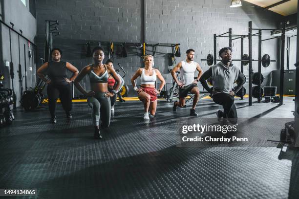 multiracial group of athletes doing lunges in gym - lunge stock pictures, royalty-free photos & images