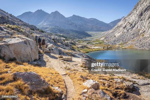 Southbound hikers walk above Palisade Lake on the John Muir Trail / Pacific Crest Trail on August 27, 2014 in the Sierra Nevada Mountains of Kings...