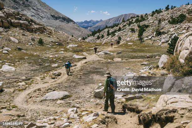 Hikers walk the John Muir Trail below Mt. Whitney near Guitar Lake in the Sierra Nevada Mountains on September 4, 2014 in Sequoia National Park,...