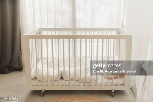 white wooden crib with bars. - cot stock pictures, royalty-free photos & images
