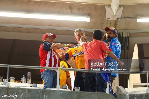 Fans of Chivas and Tigres fight after the final second leg match between Chivas and Tigres UANL as part of the Torneo Clausura 2023 Liga MX at Akron...