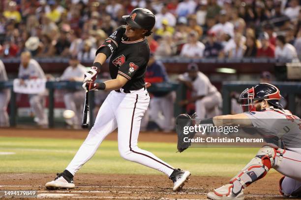 Josh Rojas of the Arizona Diamondbacks hits a RBI single against the Boston Red Sox during the first inning of the MLB game at Chase Field on May 28,...