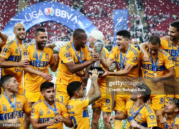 Samir Caetano and Nicolás Ibañez of Tigres hold the champions trophy after the final second leg match between Chivas and Tigres UANL as part of the...