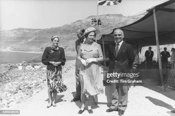 Queen Elizabeth II and the Duke of Edinburgh with King Hussein of Jordan and Queen Noor of Jordan on the shores of the Dead Sea in Jordan, 28th March...