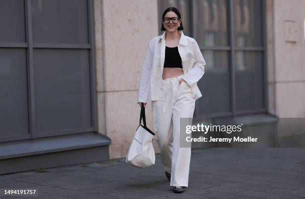 Maria Barteczko wearing ARKET white oversized linen shirt, H&M black crop top, Source Unknown off white denim baggy jeans, Stradivarius black studded...