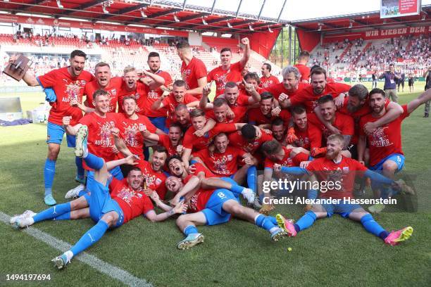 Players of 1. FC Heidenheim 1846 celebrate after the team's victory and promotion to the Bundesliga in the Second Bundesliga match between SSV Jahn...