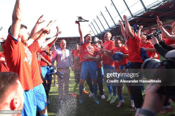 Tim Kleindienst of 1. FC Heidenheim 1846 celebrates with the golden boot award after the team's victory and promotion to the Bundesliga in the Second...